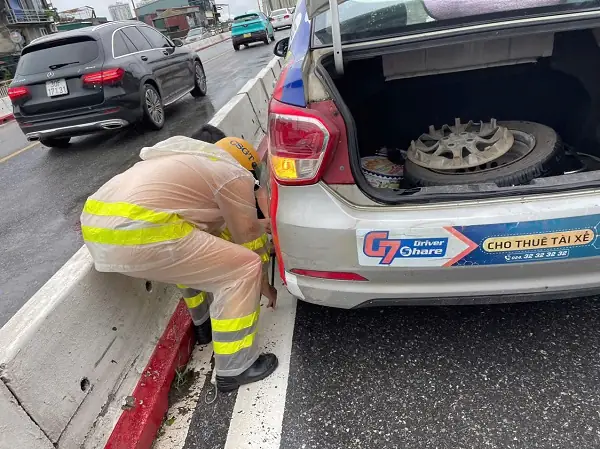 Hình Ảnh Đẹp Về Đại Úy Csgt Hỗ Trợ Thay Lốp Cho Xe Taxi Trong Ngày Mưa- Ảnh 1.